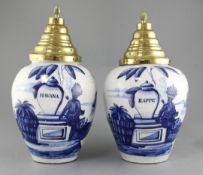 A near pair of Dutch delft blue and white tobacco jars and brass covers, late 18th century, the