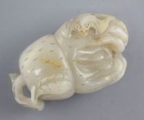 A Chinese pale grey and russet jade carving of a finger citron, carved in relief with a bat, 6.8cm