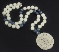 A celadon jade and two colour enamel bead necklace with carved jade pendant, with silver clasp,