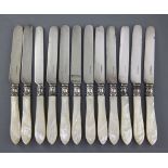 A set of twelve Victorian mother of pearl handled silver dessert knives by Aaron Hadfield,