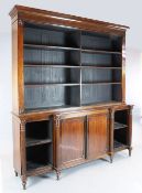 A Regency rosewood open bookcase, with six adjustable shelves over central cupboard flanked by