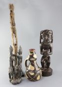 Three assorted ethnographic hardwood carvings, largest 22in. and a glazed terracotta vessel, 10.