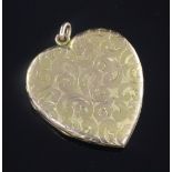 An engraved yellow metal heart shaped pendant locket, with floral scroll decoration, 47mm.