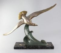L. Carvin. An Art Deco patinated bronze model of a seagull swooping over a wave, signed, width 20.