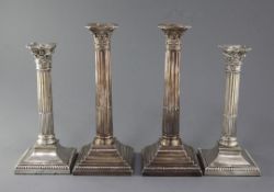 Two pairs of George V silver corinthian column candlesticks, Barker Brothers, Chester, 1922/3 and