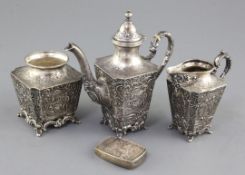 A matched late 19th/early 20th century German Hanau silver three piece tee set, embossed with