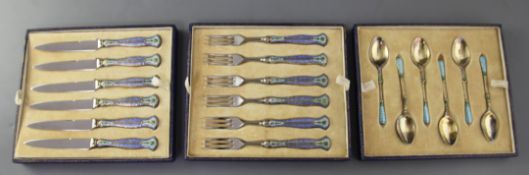 A cased set of six pairs of 1930's silver gilt and polychrome enamel handled stainless steel fruit