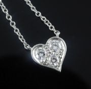 A modern Tiffany & Co platinum and three stone diamond set heart pendant necklace, with Tiffany & Co
