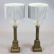 A pair of brass column oil lamps, with cut glass reservoirs, now mounted as table lamps, height