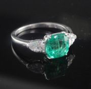 A platinum and iridium, three stone Columbian emerald and diamond ring, the 2.22ct square cushion