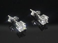 A pair of 18ct white gold and solitaire diamond ear studs, each stone weighing approximately 0.
