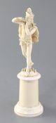 A 19th century French Dieppe ivory carving of The Pied Piper, on cylindrical socle, height 8.5in.