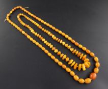 Two single strand amber bead necklaces, one with graduated oval beads, oval bead necklace- gross