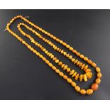 Two single strand amber bead necklaces, one with graduated oval beads, oval bead necklace- gross