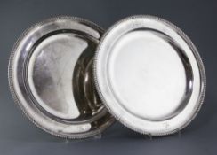 A pair of George III circular meat platters by Robert Sharp, with gadrooned borders and each with