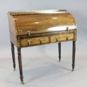 An early Victorian brass inset rosewood cylinder bureau, with fitted interior and two drawers on