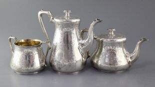 A Victorian silver three piece tea/coffee set by Daniel & Charles Houle, comprising, teapot,