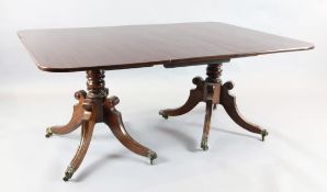 A Regency mahogany extending dining table, with D shaped ends and three spare leaves, on turned