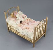 An early 20th century Austrian 'child in a bed' musical automaton, modelled with a girl sleeping