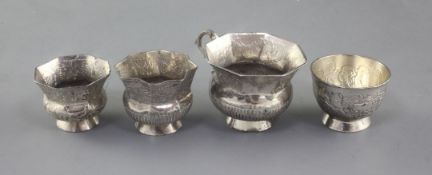 Four assorted late 18th century Russian silver vodka tots, largest dated 1791?, largest 45mm.
