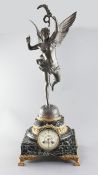 An early 20th century French bronzed spelter and green marble mantel clock, surmounted with a figure