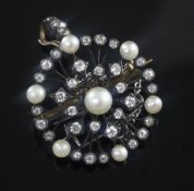 An early 20th century gold and silver, diamond and cultured pearl set openwork circular pendant