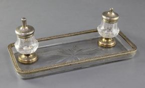 A late 19th/early 20th century French 950 standard silver gilt mounted rectangular glass inkstand by