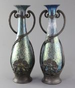 A pair of Loetz style iridescent glass vases, with stylish Austrian Art Nouveau pewter mounts,