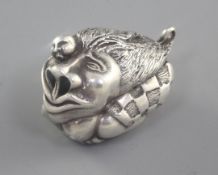 A Japonaise silver miniature netsuke style figural group of a stylised lion with figure, unmarked,