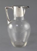 A Victorian silver mounted glass claret jug, in the manner of Christopher Dresser, by Hukin and