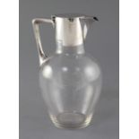 A Victorian silver mounted glass claret jug, in the manner of Christopher Dresser, by Hukin and