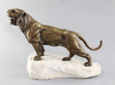Louis Hesteaux. An Art Deco bronze model of a roaring tiger, on signed naturalistic rock plinth,