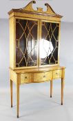 An Edwardian Sheraton Revival marquetry inlaid satinwood bookcase, with two astragal glazed doors