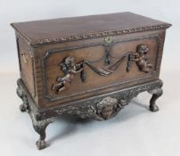 An 18th century Irish style mahogany coffer, with gadrooned top and carved with cherubs, swags and