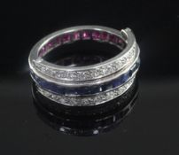 A white gold, ruby, sapphire and diamond set triple band swivel ring, size M.