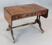 A Regency mahogany sofa table, with twin end columns and fluted downswept legs, W.3ft 2in. D.2ft H.