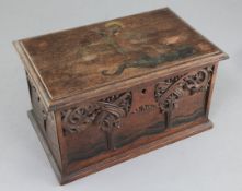 An Arts & Crafts carved and painted mahogany casket, the lid decorated with St George and the