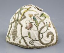 An early 18th century embroidered silk and metal thread cap, woven with flowers and scrolling