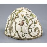 An early 18th century embroidered silk and metal thread cap, woven with flowers and scrolling