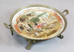 A Lille faience and brass mounted dish, late 19th / early 20th century, the top painted with a