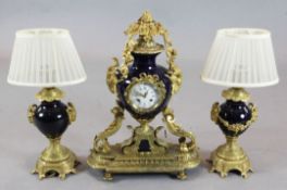 A French ormolu and bleu du rois porcelain clock garniture, with central urn shaped clock, 22in.,