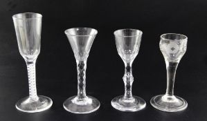 Four 18th century wine glasses, one with opaque twist stem, two with facetted stems and one with