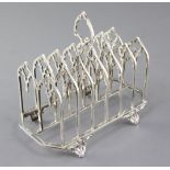 A Victorian gothic style seven bar toastrack by Thomas Smily, on four scroll feet, London, 1872, 6.