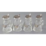 A set of four 1930's silver topped glass whisky tot jugs by Goldsmiths & Silversmiths Co Ltd,