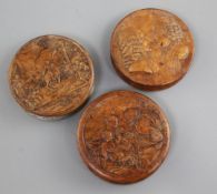 Three 19th century French Bois Durci snuff boxes, decorated Voltaire and Russo, a nativity scene and