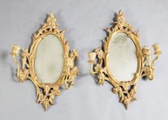 A pair of George III giltwood two light girandoles, with oval plates, W.1ft 3in. H.2ft