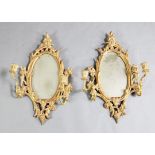 A pair of George III giltwood two light girandoles, with oval plates, W.1ft 3in. H.2ft