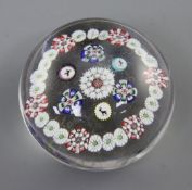 A Baccarat millefiori glass paperweight, 19th century decorated with a millefiori band and goat, dog