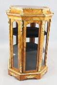 A French ormolu mounted tulipwood vitrine, of octagonal free-standing form, with central