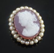 A late 19th/early 20th century French 18ct gold, diamond and split pearl set oval hardstone cameo